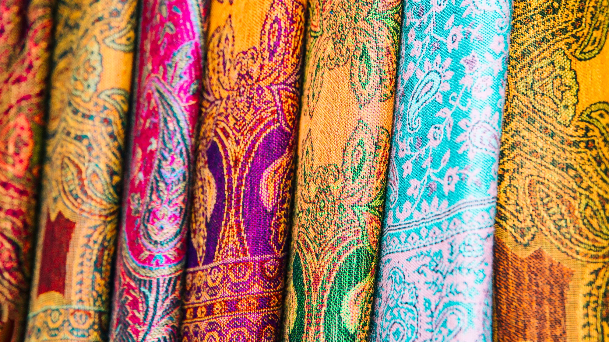 A white box containing an assortment of colorful fabric pieces arranged neatly inside.