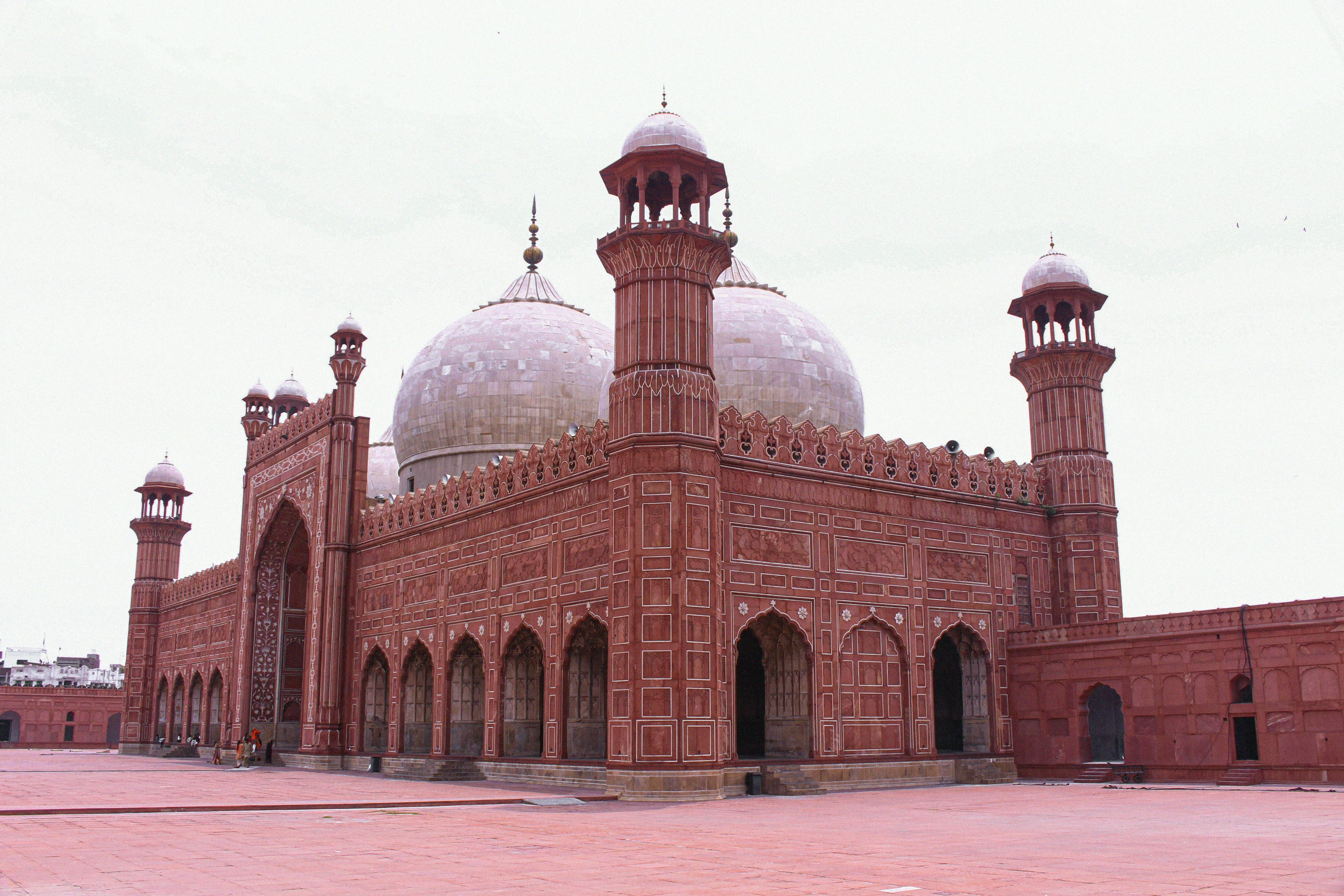 A large building featuring multiple domes, showcasing intricate architectural design and grandeur.              
